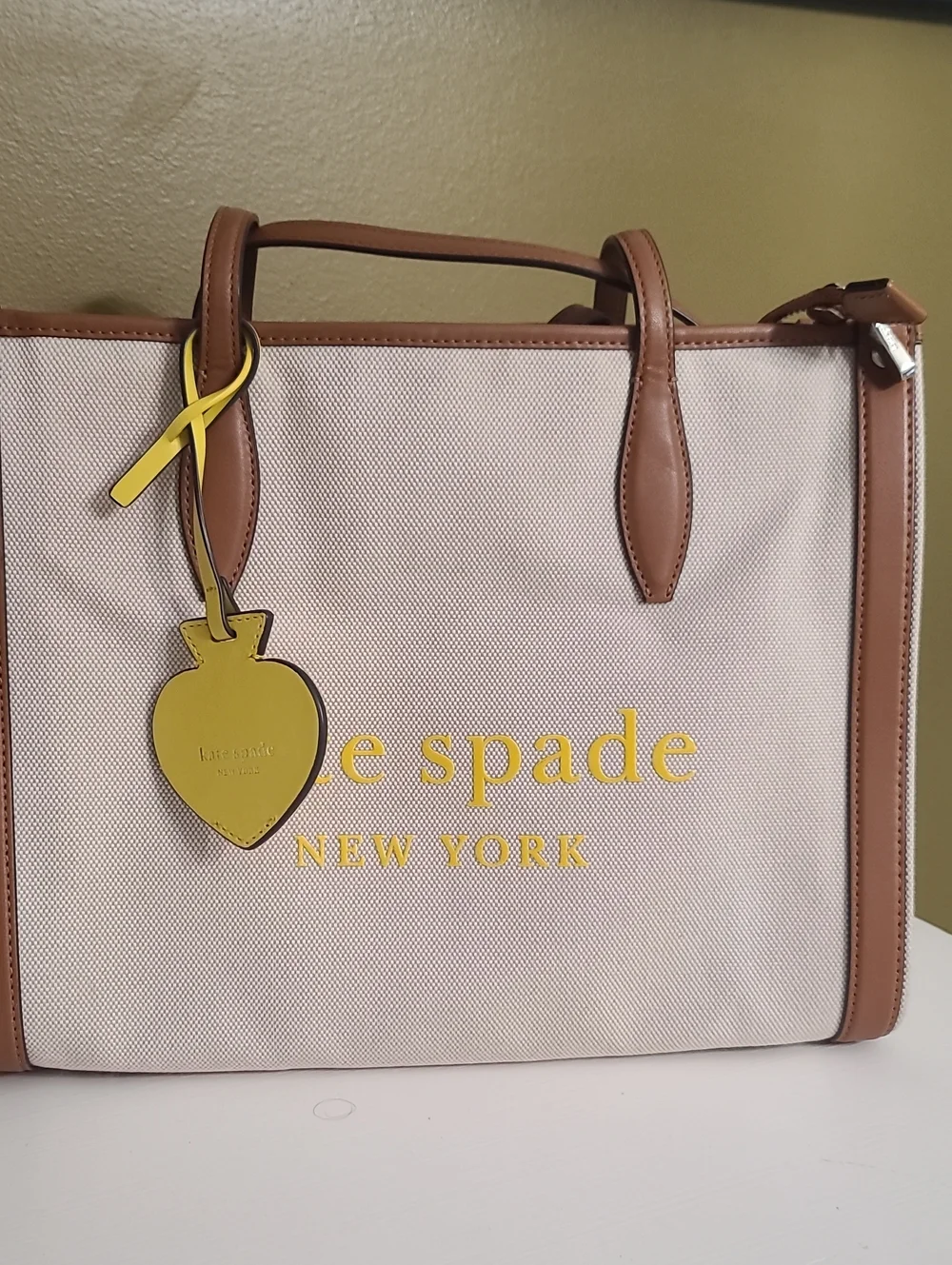 kate spade Beige Canvas Tote with Brown Trim and Yellow Charm